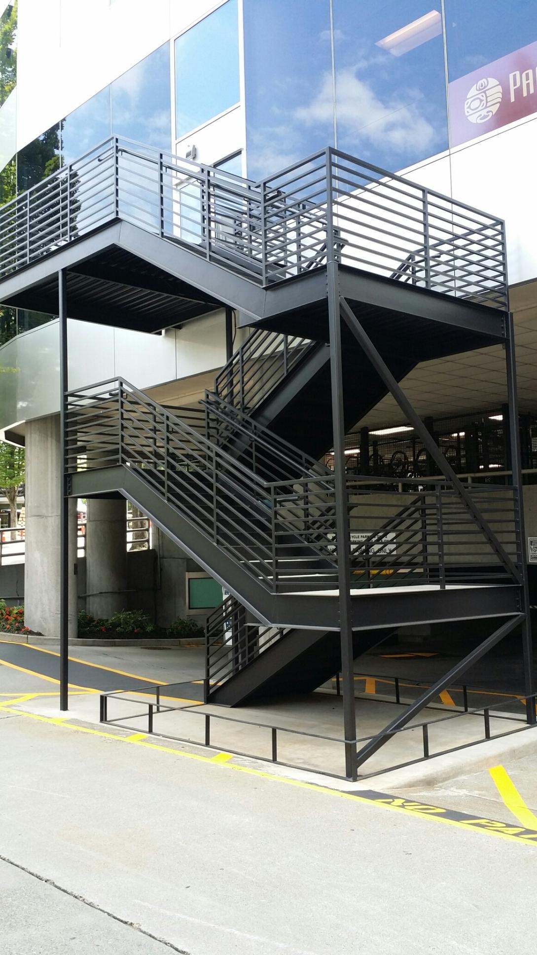Finished exterior structural steel staircase with steel railings